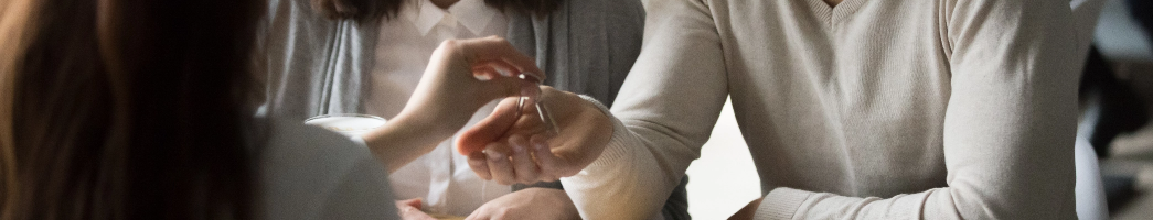 Two sets of hands show one person handing keys to another person.